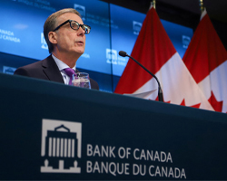US-Stocks-Drop-as-Inflation-Data-Dampens-Rate-Cut-Hopes-Bank-of-Canada-Holds-Rates-Steady-Amid-Rate-Cut-Speculation-Preview